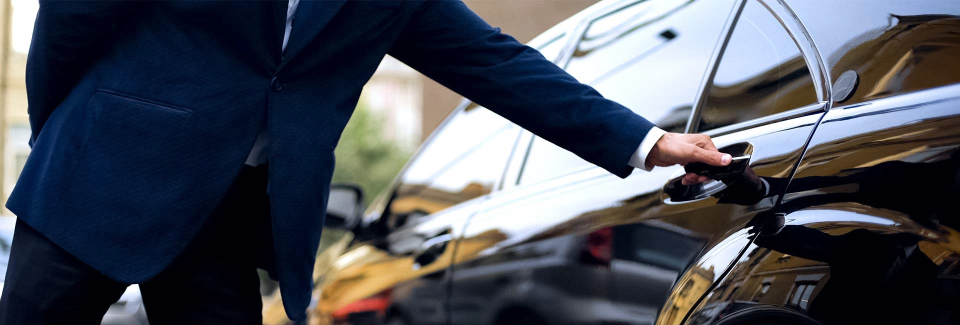driver opening black car door